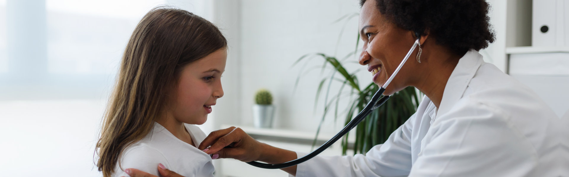 Doctor examining child with stethoscope